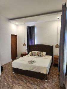 a bedroom with a large bed in a room at Serah's Homestay in Kuta Lombok +39 photos