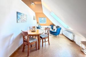 a dining room with a table and chairs and a staircase at Gästehaus Maria Rast in Suderburg