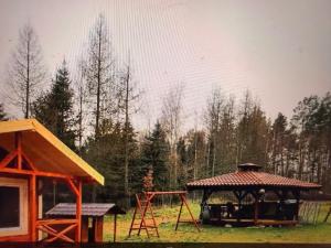 a playground with a gazebo and a swing at Eco domki Mazury in Ruciane-Nida
