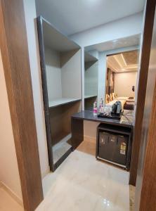 a kitchen with a counter and a large mirror at Hotel Smart International in New Delhi