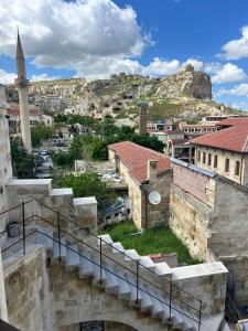 a view of a city with a church and a mountain at la mar cave cappadocia in Ürgüp