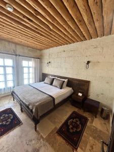 a bedroom with a large bed in a brick wall at la mar cave cappadocia in Ürgüp