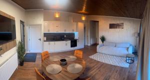 a living room with a table and a couch at WiNGS Retreat in Lupşa