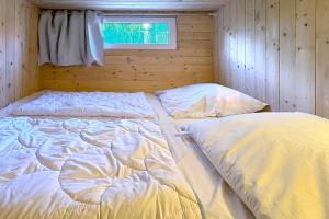 a bedroom with two beds in a wooden wall at Gästehaus Maria Rast in Suderburg +128 photos
