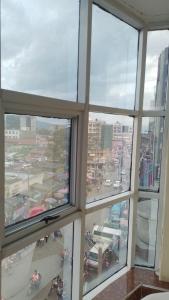 a view of a city from an office window at Claire de Lune Moonlight Hotel in Nakuru