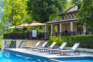 a row of lounge chairs next to a swimming pool at Siddhartha Riverside Resort, Chumlingtar in Makaising