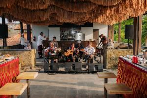 a group of people playing music in a restaurant at Anhera Suite Ubud in Ubud