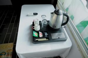 a tea kettle on top of a table at Sattva camps and cottages - Udupi in Udupi