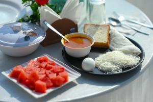 a table with a plate of food and a bowl of soup at Sattva camps and cottages - Udupi in Udupi