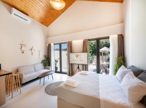 a bedroom with a large bed and a living room at Anamu Suites in Kondáraina +50 photos