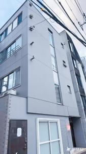 a white building with windows on the side of it at Youki Residence in Tokyo