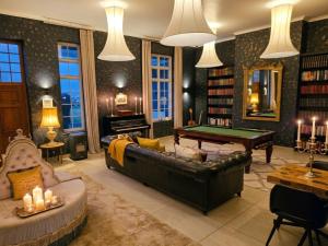a living room with a couch and a pool table at Maison PJURE Boutique Hotel & Spa , Adults Only in Montagu