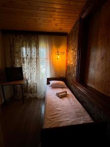 a bedroom with two beds and a desk and a window at Art Vila Galeri in Kazbegi +47 photos