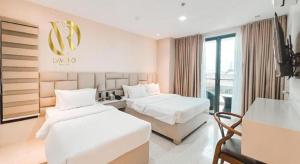 a hotel room with two beds and a sign on the wall at LAVERO SUITES in Kalibo +206 photos