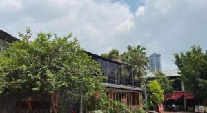 a building with trees in front of a building at H Life Hotel in Shenzhen