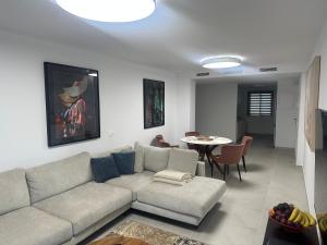 a living room with a couch and a table at Luxury La Cala de Mijas Sunset in Mijas Costa