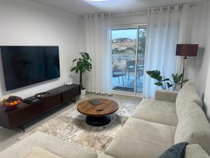 a living room with a couch and a table at Luxury La Cala de Mijas Sunset in Mijas Costa