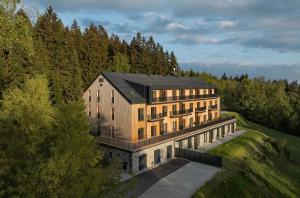 an aerial view of a building in the woods at Krkonoše - apartmán s výhledem in Benecko