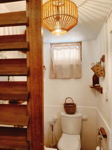 a bathroom with a toilet and a chandelier at Memo's Beach in Nilaveli +119 photos