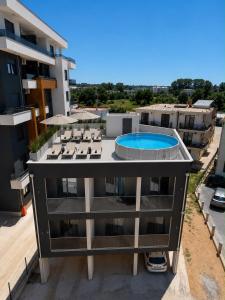 an aerial view of a building with a swimming pool at Maxhuri Apartments in Ulcinj
