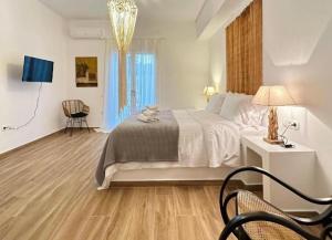 a bedroom with a bed and a table and chairs at La maison - Two Private Apartments, One with Private Pool in Angairiá +97 photos