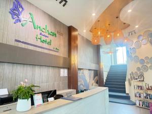 a lobby of a hotel with a staircase and a sign at Anchan Hotel & Spa in Hua Hin +79 photos
