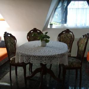 a table with chairs and a potted plant on it at KASZÁS HÁZ in Hajdúszoboszló