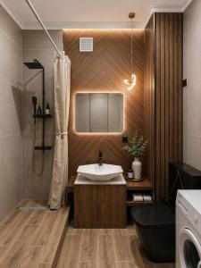 a bathroom with a sink and a washing machine at Elim-Ai in Kokshetau