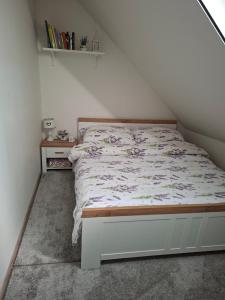 a bedroom with a bed with a white bed frame at Apartmán Bobo in Stožok
