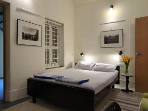a bedroom with a large bed in a room at Disharee 51A in Kolkata