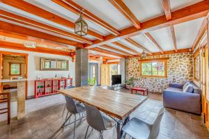 a kitchen and living room with a wooden table and chairs at La cara Luna in Santa Brígida