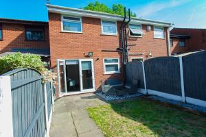 a brick house with a fence in front of it at The Cheshire ABode- Central Warrington- Stadium, Station Access- Sleeps 5 in Warrington