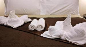 a group of towels on top of a bed at Peridot Suites in Buhangin