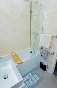a bathroom with a shower and a sink and a tub at The Cheshire ABode- Central Warrington- Stadium, Station Access- Sleeps 5 in Warrington +15 photos