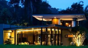 a large house with a lot of windows at night at Villa De View in Ban Tham
