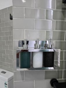 a bathroom with a sink and two toilets at Hotel Velmont Kandy in Kandy