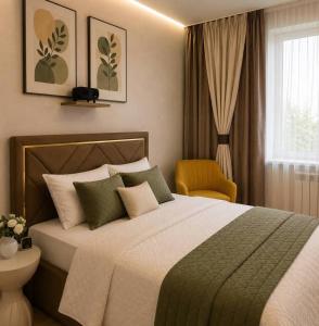 a bedroom with a large bed and a yellow chair at Elim-Ai in Kokshetau