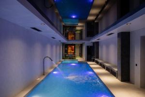 a swimming pool with blue lights in a building at Lavanda hotel Tashkent in Tashkent