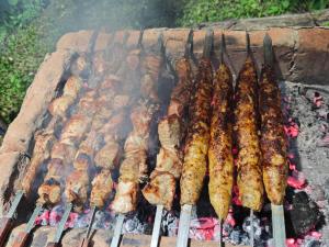 a bunch of food cooking on a grill at Zarati House 