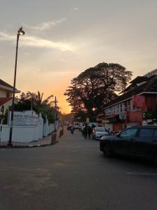 a street with cars parked on the side of the road at Hope Hostels, Fort Kochi in Fort Kochi +4 photos