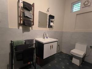 a bathroom with a sink and a toilet and towels at Mad about Coco Yoga & Beach Retreat in Varkala +144 photos