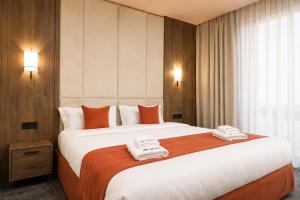 a hotel room with a large bed with towels on it at Urban Hotel Ethno in Bishkek +25 photos