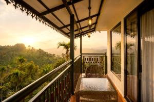 a balcony with benches and a view of the mountains at Ynad Mount Resort in Meppādi