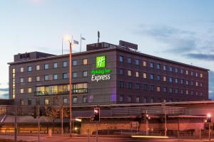 a building with a sign that reads happy hour express at Holiday Inn Express Bradford City Centre by IHG in Bradford