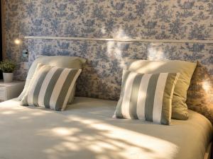 a bedroom with a bed with two pillows at Domaine de la Jasseix in Croze