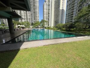 a large swimming pool in a city with tall buildings at Highbury Colombo in Colombo