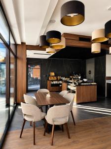 a dining room with a wooden table and chairs at Ski and Bike Residence in Istebna