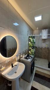 a bathroom with a sink and a stove at Rinat Guest House in Pokrovka +14 photos