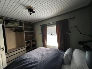 a bedroom with a bed and a window at Fishermans luck in Arvidsjaur +8 photos