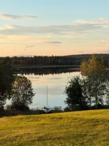 a sailboat sitting on the shore of a lake at Fishermans luck in Arvidsjaur